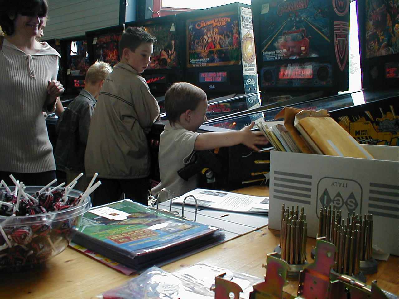 kids playing pinball machines