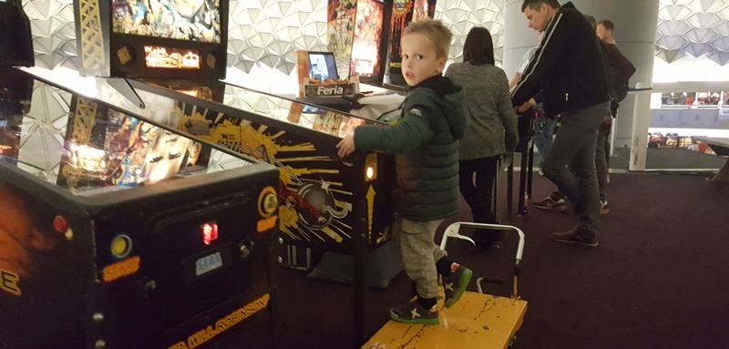 kid playing pinball