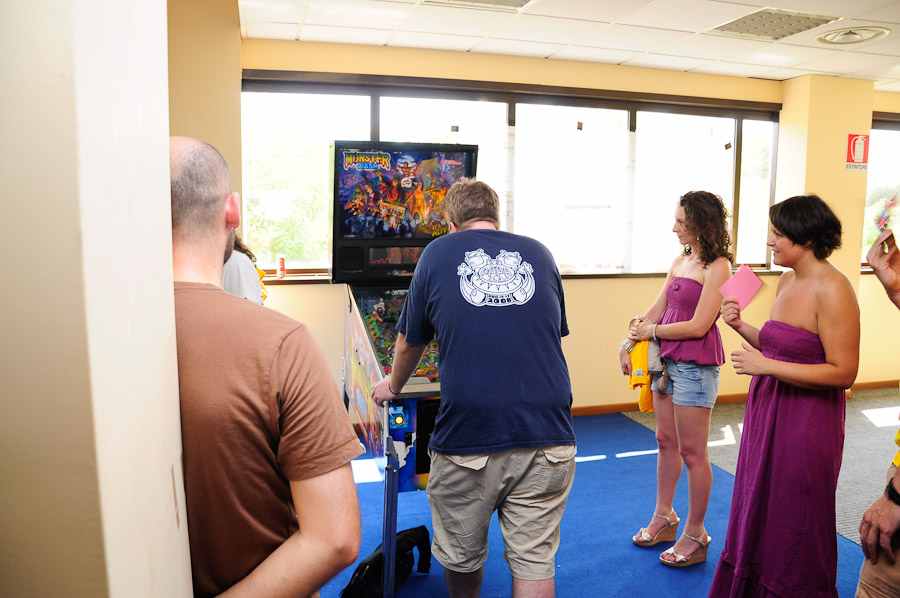 women looking at Monster Bash pinball machine